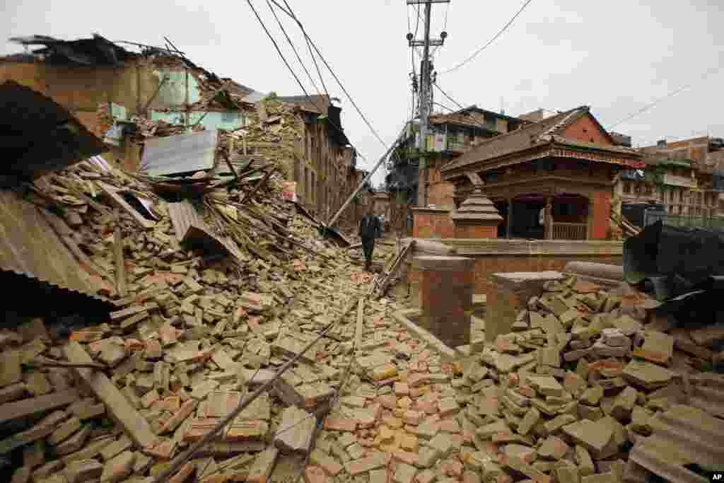 A Nepalese man walks through destruction caused by Saturday's earthquake, in Bhaktapur, Nepal.