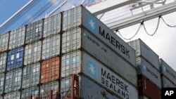 FILE - containers wait to be unloaded from a ship at the Port of Baltimore in Baltimore. 
