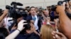 Venezuelan Congress President Juan Guaido, an opposition leader who declared himself interim president, waves from the scaffolding after speaking at a rally demanding the resignation of President Nicolas Maduro in Caracas, March 4, 2019. 