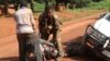 In this Sept. 16, 2013 photo, A Gabonese soldier from a regional Central African peacekeeping force helps collect the bodies of rebels who were reportedly killed by armed villagers in Njoh, Central African Republic.