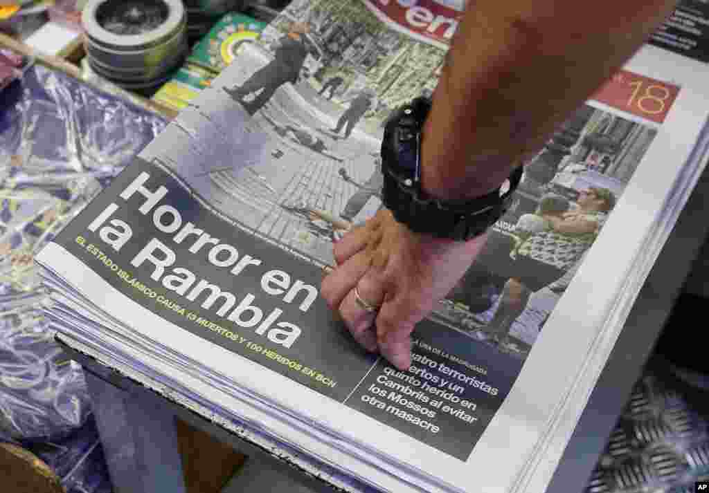 A newspaper displays a photograph of the aftermath of the terror attack in Las Ramblas, in Barcelona, Spain, Aug. 18, 2017. 