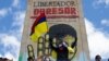 A protester waves a Colombian flag in front of a monument honoring Simon Bolivar in Bogota, Colombia, July 20, 2021. (Megan Janetsky/VOA)