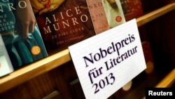 FILE - Books by Canadian writer Alice Munro, the 2013 Nobel Prize in Literature winner, are displayed during the book fair in Frankfurt, Oct. 10, 2013. 