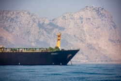 A view of the Grace 1 supertanker is seen backdropped by Gibraltar's Rock, as it stands at anchor in the British territory of Gibraltar, Aug. 15, 2019.