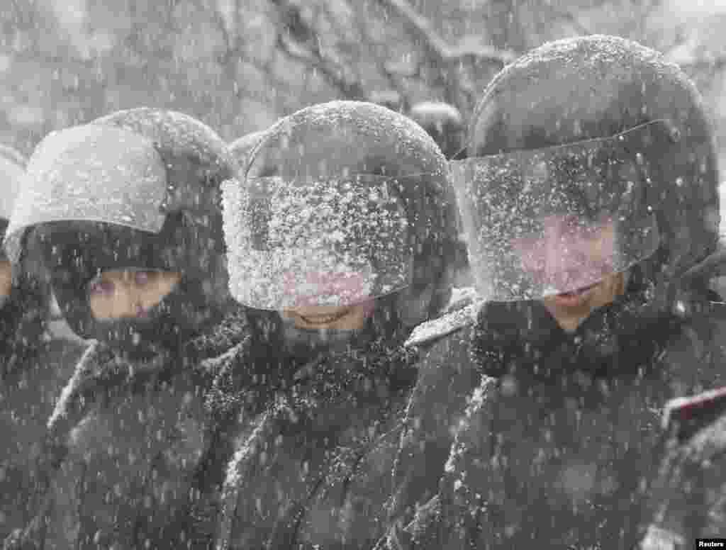 Ukrainian police officers stand in line during protests in Kyiv, Dec. 6, 2013. 