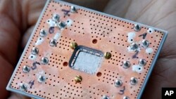 This Feb. 27, 2018, photo shows a seven cubit quantum device is seen at the IBM Thomas J. Watson Research Center in Yorktown Heights, N.Y. Conventional computers process information as a stream of bits, each of which can be either a zero or a one in…