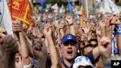 Supporters of leader of The League party Matteo Salvini chant slogans at the party's rally in Pontida, northern Italy, Sept. 15, 2019. 