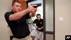Trainees Chris Graves, left, and Bryan Hetherington, right, participate in a security training session at Fellowship of the Parks campus in Haslet, Texas, July 21, 2019.