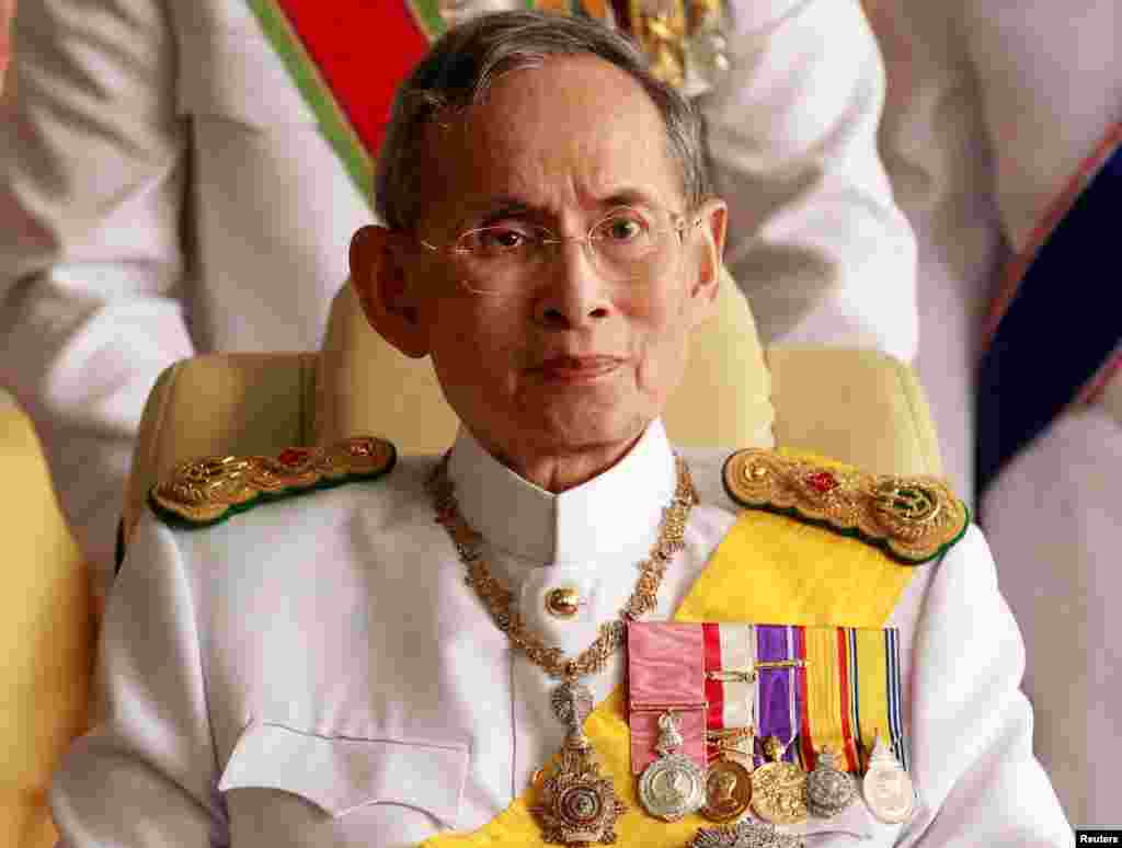 FILE - Thailand's King Bhumibol Adulyadej leaves the Siriraj Hospital for a ceremony at the Grand Palace in Bangkok.