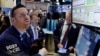 Specialist Frank Masiello, left, works at his post on the floor of the New York Stock Exchange, Nov. 7, 2016. Stocks opened sharply higher on Wall Street after the FBI said newly discovered emails didn't warrant any action against presidential candidate Hillary Clinton. 
