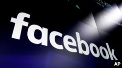 FILE - The logo for social media giant Facebook appears on screens at the Nasdaq MarketSite, in New York's Times Square, March 29, 2018.