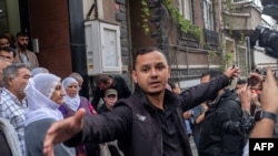 A police officer blocks journalists during a demonstration at a pro-Kurdish Peoples' Democracy Party office after some of their members were detained early in the morning on Oct. 2, 2023. Turkey detained at least 67 people with suspected links to a Kurdish militant group.
