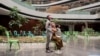 A boy stands with his family in the Discovery vaccination site as he waits to receive his first jab of Pfizer/BioNTech vaccine against COVID-19 in Sandton, Johannesburg, Dec. 15, 2021.