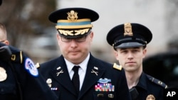 Army Lieutenant Colonel Alexander Vindman, a military officer at the National Security Council, center, arrives on Capitol Hill in Washington, to testify as part of the impeachment inquiry into President Donald Trump, Oct. 29, 2019. 