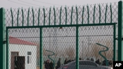 FILE - Residents line up inside a vocational training center in Artux, in western China's Xinjiang region, Dec. 3, 2018. Critics say China uses some of these facilities as detention camps for forced labor. 
