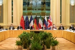 FILE - Attendees wait for the start of a meeting of the JCPOA Joint Commission in Vienna, Austria, April 17, 2021. (EU Delegation in Vienna/Handout via Reuters)