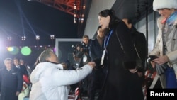 South Korean President Moon Jae-in shakes hands with Kim Jong Un's younger sister Kim Yo Jong at the Winter Olympics opening ceremony in Pyeongchang, South Korea February 9, 2018. Yonhap via REUTERS 