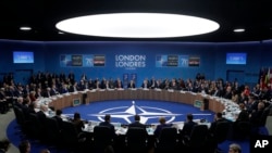 Officials participate in a roundtable meeting during a NATO leaders summmit at The Grove hotel and resort in Watford, England, Wed. Dec. 4, 2019.