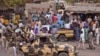 File - Nigerian soldiers ride on the back of an armed truck as they patrol at a local market Tuesday, Jan. 27, 2015, after recent violence in surrounding areas at Maiduguri, Nigeria. Islamic extremists are rampaging through villages in northeast Nigeria’s