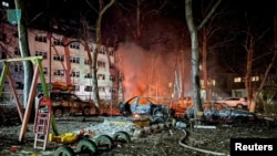 Destroyed cars are seen next to a residential building damaged during a Russian drone strike, amid Russia's attack on Ukraine, in Odesa, Ukraine, Jan. 17, 2024. (Press Service of the Operational Command 'South'/Handout via Reuters). 