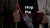 FILE - A man's T-shirt reads "Stop the Cut" referring to Female Genital Mutilation during a social event advocating against such harmful practices at the Imbirikani Girls High School in Imbirikani, Kenya, April 21, 2016.