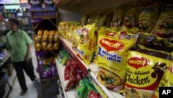 FILE - Packaged food with "Maggi" sign on it are displayed at a grocery store in Bangalore, India, June 5, 2015.