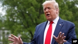 President Donald Trump speaks with reporters on the South Lawn of the White House as he departs on Marine One, May 14, 2020, in Washington. 