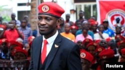 FILE - Ugandan musician turned politician, Robert Kyagulanyi, also known as Bobi Wine, arrives at the news conference at his home in Kasangati, Kampala, Uganda, July 24, 2019.