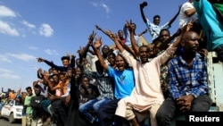 FILE - Protesters gesture and shout slogans as they demonstrate against the Sudanese military's recent seizure of power and ousting of the civilian government, in Khartoum, Sudan, Oct. 30, 2021.