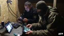 Soldados del batallón de complejos de aviones de ataque no tripulados "Aquiles" de la 92.ª Brigada de Asalto Separada observan al enemigo refugiado en una posición de frente cerca de la ciudad de Chasiv Yar, Donetsk, el 22 de abril de 2024. [Foto de Anatolii STEPANOV / AFP]