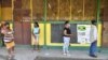 Masked voters stand in line before casting their ballots in Jamaica's St. Catherine north central constituency during the general election, September 3,2020.
