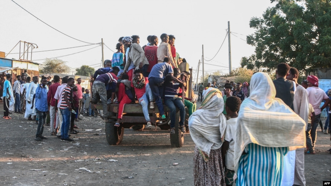 People fleeing intense fighting in Ethiopia's Tigray region gather in the bordering Sudanese village 8, east of the town of Gadaref, Nov. 13, 2020. 