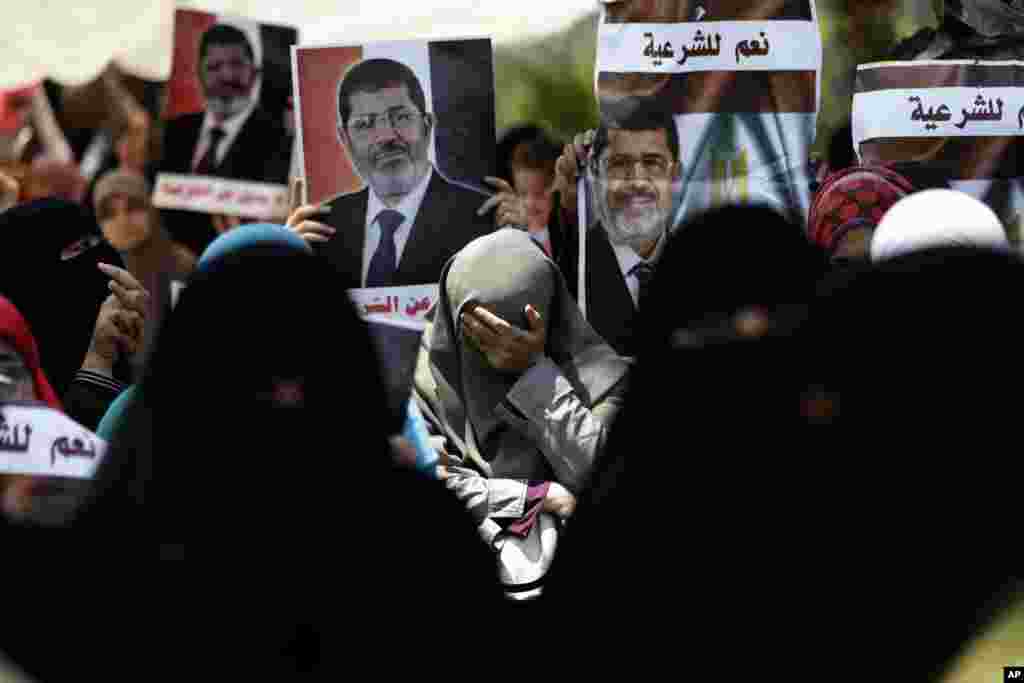 A supporter of ousted Egyptian President Mohammed Morsi cries during a protest near the University of Cairo, Giza, July 5, 2013.
