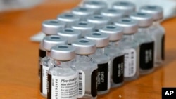 FILE - Pfizer COVID-19 vaccines sit ready for use at a Dallas County Health and Human Services drive up vaccine site in Mesquite, Texas, Nov. 30, 2021. 