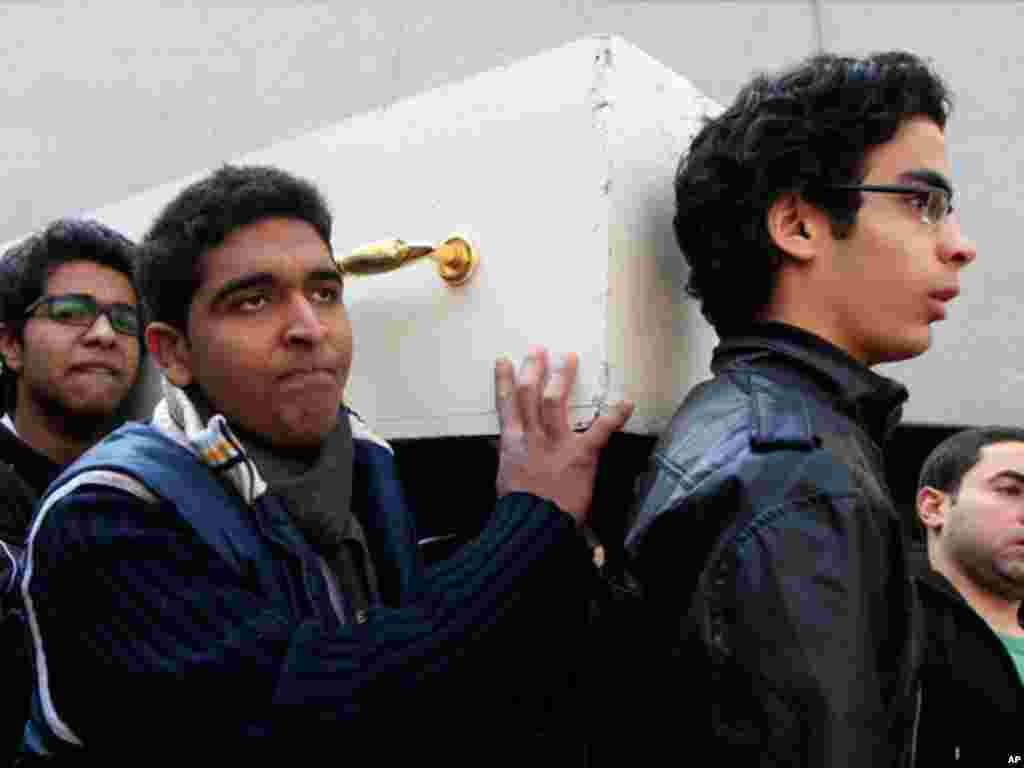 Egyptians carry a coffin with the body of their relative who was killed during clashes at a soccer stadium. February 2, 2012. (AP)