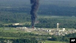 Smoke rises from a chemical plant in Crosby, near Houston, Texas, Sept. 1, 2017. Thick black smoke and towering orange flames shot up Friday from the flooded Houston-area chemical plant after two trailers of highly unstable compounds blew up a day earlier