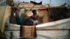 Christian refugees create a home for themselves in makeshift shelters near the airport in Bangui, Central African Republic, Tuesday Jan. 28, 2014, as they try to escape from the deepening divisions between the country's Muslim minority and Christian major