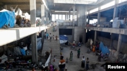 FILE - Displaced people are seen inside a building under construction at the Shire campus of Aksum University, which was turned into a temporary shelter for people displaced by conflict, in the town of Shire, Tigray region, Ethiopia, March 14, 2021. 