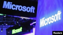 A variety of logos hover above the Microsoft booth on at the International Consumer Electronics Show in Las Vegas, January 10, 2012.