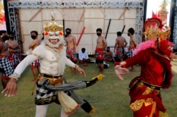 Traditional dancers wear costumes as they prepare their performance in Bali, Indonesia on July 30, 2020. Indonesia's resort island of Bali will reopen Friday.