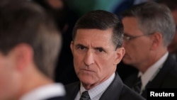 FILE - Then-White House national security adviser Michael Flynn, center, arrives at the White House in Washington, Feb. 13, 2017.