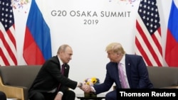Russia's President Vladimir Putin and U.S. President Donald Trump shake hands during a bilateral meeting at the G-20 leaders summit in Osaka, Japan, June 28, 2019.