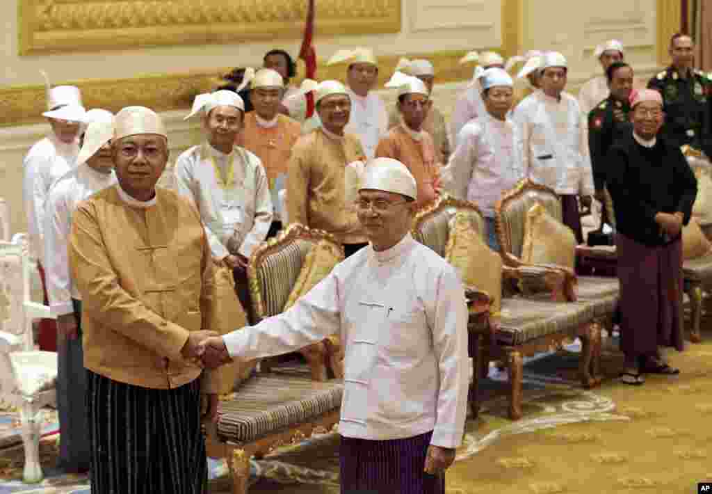 Myanmar's new president Htin Kyaw, left, shakes hands with outgoing president Thein Sein, during a handover ceremony in Naypyitaw.
