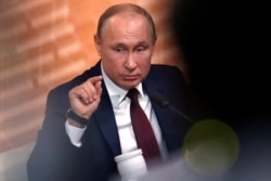 Russian President Vladimir Putin gestures during his annual end-of-year news conference in Moscow, Dec. 19, 2019.