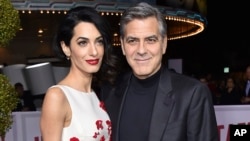 FILE - Amal Clooney, left, and George Clooney arrive at the world premiere of "Hail, Caesar!" in Los Angeles.