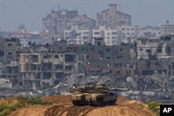Israeli soldiers on a tank at a position on the border with the Gaza Strip, in southern Israel, March 19, 2024.