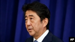 FILE - Japanese Prime Minister Shinzo Abe speaks at a luncheon with President Donald Trump and South Korean President Moon Jae-in at the Palace Hotel during the United Nations General Assembly, Sept. 21, 2017, in New York. 