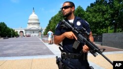 FILE - Capitol Hill Police officer Nathan Rainey stands guard on Capitol Hill in Washington, after House Majority Whip Steve Scalise of Louisiana was shot during a congressional baseball practice in Alexandria, Virginia, June 14, 2017.