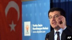 FILE - Turkish Minister of Economic Affairs Nihat Zeybekci speaking inside a hotel in Cologne, Germany.