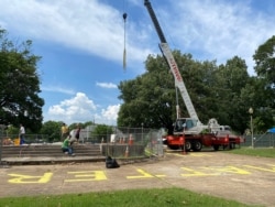 Workers dig up the remains of Confederate Gen. Nathan Bedford Forrest and his wife to move the bodies from Health Sciences Park, June 4, 2021, in Memphis, Tenn.
